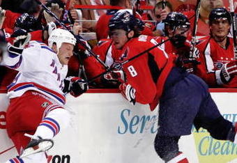 WASHINGTON - APRIL 15:  Alex Ovechkin #8 of the Washington Capitals checks Sean Avery #16 of the New York Rangers along the boards during Game One of the Eastern Conference Quarterfinals of the 2009 NHL Stanley Cup Playoffs on April 15, 2009 at the Verizon Center in Washington, DC.  (Photo by Len Redkoles/Getty Images)