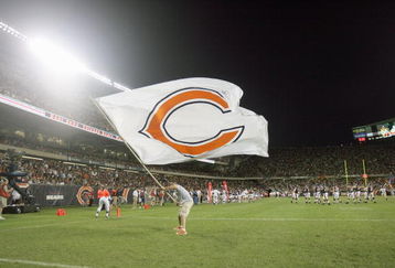 CHICAGO - AUGUST 25: A cheerleader of the Chicago Bears waves a Bears flag during the game against the San Francisco 49ers on August 25, 2007 at Soldier Field in Chicago, Illinois. (Photo by Jonathan Daniel/Getty Images)