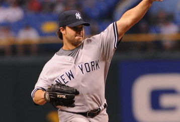 ST. PETERSBURG, FL - APRIL 13: Infielder Nick Swisher #33 of the New York Yankees pitches the eight inning against the Tampa Bay Rays April 13, 2009 in St. Petersburg, Florida.  (Photo by Al Messerschmidt/Getty Images)