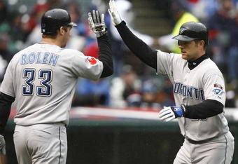 CLEVELAND - APRIL 10:  Adam Lind #26 (R) of the Toronto Blue Jays celebrates with Scott Rolen #33 after scoring against the Cleveland Indians in the fourth inning April 10, 2009 at Progressive Field in Cleveland, Ohio.  (Photo by Matt Sullivan/Getty Images)