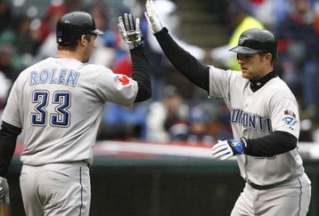CLEVELAND - APRIL 10:  Adam Lind #26 (R) of the Toronto Blue Jays celebrates with Scott Rolen #33 after scoring against the Cleveland Indians in the fourth inning April 10, 2009 at Progressive Field in Cleveland, Ohio.  (Photo by Matt Sullivan/Getty Images)