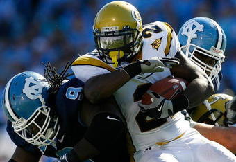 CHAPEL HILL, NC - NOVEMBER 08:  Running back Jonathan Dwyer #21 of the Georgia Tech Yellow Jackets runs into Marvin Austin #9 of the North Carolina Tar Heels during the game at Kenan Stadium on November 8, 2008 in Chapel Hill, North Carolina.  (Photo by Kevin C. Cox/Getty Images)