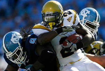 CHAPEL HILL, NC - NOVEMBER 08:  Running back Jonathan Dwyer #21 of the Georgia Tech Yellow Jackets runs into Marvin Austin #9 of the North Carolina Tar Heels during the game at Kenan Stadium on November 8, 2008 in Chapel Hill, North Carolina.  (Photo by Kevin C. Cox/Getty Images)