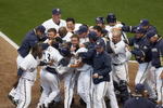 MILWAUKEE - APRIL 10: Members of the Milwaukee Brewers mob teammate Rickie Weeks #23 after Weeks scored the winning run in the bottom of the 9th inning against the Chicago Cubs during the Opening Day game on April 10, 2009 at Miller Park in Milwaukee, Wisconsin. The Brewers defeated the Cubs 4-3. (Photo by Jonathan Daniel/Getty Images)