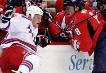 WASHINGTON - APRIL 15:  Alex Ovechkin #8 of the Washington Capitals checks Sean Avery #16 of the New York Rangers along the boards during Game One of the Eastern Conference Quarterfinals of the 2009 NHL Stanley Cup Playoffs on April 15, 2009 at the Verizon Center in Washington, DC.  (Photo by Len Redkoles/Getty Images)