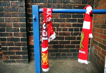 SHEFFIELD, ENGLAND - APRIL 14:  Floral tributes and Liverpool scarves lay in tribute next to the Leppings Lane entrance of Hillsborough Stadium on the eve of the 20th anniversary of the Hillsborough disaster on April 14, 2009, Sheffield, England. Sheffield Wednesday FC are not holding an official service to mark the disaster but will be opening the Leppings lane end for people wishing to pay their respects. A total of 96 Liverpool supporters lost their lives during a crush at an FA Cup semi final against Nottingham Forest at the Hillsborough football ground in Sheffield, South Yorkshire on April 15, 1989.  (Photo by Christopher Furlong/Getty Images)