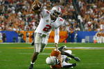 GLENDALE, AZ - JANUARY 05:  Quarterback Terrelle Pryor #2 of the Ohio State Buckeyes scrambles with the ball under pressure from Ryan Palmer #13 of the Texas Longhorns during the Tostitos Fiesta Bowl Game on January 5, 2009 at University of Phoenix Stadium in Glendale, Arizona.  (Photo by Jeff Gross/Getty Images)