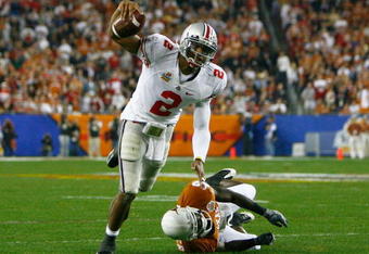 GLENDALE, AZ - JANUARY 05:  Quarterback Terrelle Pryor #2 of the Ohio State Buckeyes scrambles with the ball under pressure from Ryan Palmer #13 of the Texas Longhorns during the Tostitos Fiesta Bowl Game on January 5, 2009 at University of Phoenix Stadium in Glendale, Arizona.  (Photo by Jeff Gross/Getty Images)