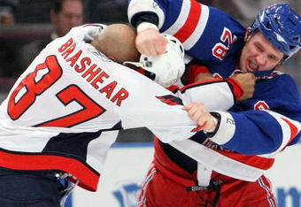 NEW YORK - FEBRUARY 11:  Colton Orr #28 of the New York Rangers fights with Donald Brashear #87 of the Washington Capitals on February 11, 2009 at Madison Square Garden in New York City, New York.  (Photo by Nick Laham/Getty Images)