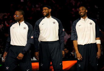 PHOENIX - FEBRUARY 15:  (L-R) Dwyane Wade, LeBron James and Kobe Bryant, members of the women's and men's gold medal winning USA Olympic basketball teams, wave to the crowd during half time of the 58th NBA All-Star Game, part of 2009 NBA All-Star Weekend at US Airways Center on February 15, 2009 in Phoenix, Arizona.  NOTE TO USER: User expressly acknowledges and agrees that, by downloading and or using this photograph, User is consenting to the terms and conditions of the Getty Images License Agreement.  (Photo by Ronald Martinez/Getty Images)