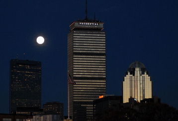 BOSTON - OCTOBER 25:  A rising moon is seen behind the Prudential Building (C), part of the downtown Boston skyline, prior to Game Two of the 2007 Major League Baseball World Series at Fenway Park  between the Boston Red Sox and the Colorado Rockies on October 25, 2007 in Boston, Massachusetts.  (Photo by Darren McCollester/Getty Images)