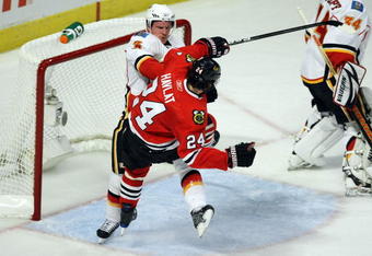 CHICAGO - APRIL 18:  Dion Phaneuf #3 of the Calgary Flames checks Martin Havlat #24 of the Chicago Blackhawks off of his skates during the first period of Game Two of the Western Conference Quarterfinals of the 2009 Stanley Cup Playoffs on April 18, 2009 at the United Center in Chicago, Illinois.  (Photo by Jonathan Daniel/Getty Images)