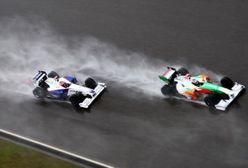 SHANGHAI, CHINA - APRIL 19:  Adrian Sutil (R) of Germany and Force India and Robert Kubica (L) of Poland and BMW Sauber drive during the Chinese Formula One Grand Prix at the Shanghai International Circuit on April 19, 2009 in Shanghai, China.  (Photo by Clive Mason/Getty Images)