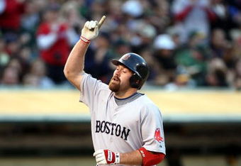 OAKLAND, CA - APRIL 13: Kevin Youklis #20 of the Boston Red Sox celebrates after hitting a home run in the first inning against the Oakland Athletics during a Major League Baseball game on April 13, 2009 at the Oakland Coliseum in Oakland, California.  (Photo by Jed Jacobsohn/Getty Images)