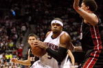 ATLANTA - APRIL 19: Josh Smith #5 of the Atlanta Hawks drives around Michael Beasley #30 of the Miami Heat during Game One of the First Round of the Eastern Conference Playoffs at Philips Arena on April 19, 2009 in Atlanta, Georgia. The Hawks defeated the Heat 90-64. NOTE TO USER: User expressly acknowledges and agrees that, by downloading and/or using this Photograph, user is consenting to the terms and conditions of the Getty Images License Agreement. (Photo by Doug Benc/Getty Images)