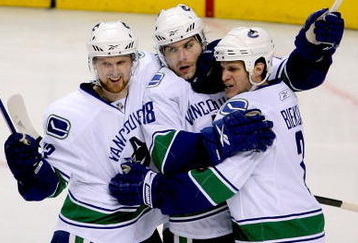 ST LOUIS, MO - APRIL 19: Steve Bernier #18 of the Vancouver Canucks is congratulated by teammates Henrik Sedin #33 and Kevin Bieksa #3 after scoring the go ahead goal against the St Louis Blues in the second period during Game Three of the Western Conference Quarterfinal Round of the 2009 Stanley Cup Playoffs on April 19, 2009 at Scottrade Center in St. Louis, Missouri. (Photo by Matthew Stockman/Getty Images)