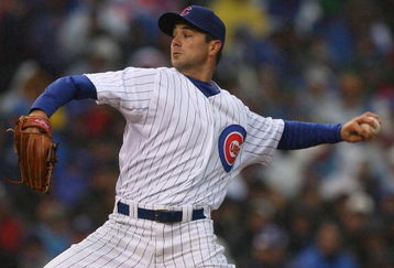 CHICAGO - APRIL 13: Starting pitcher Ted Lilly #30 of the Chicago Cubs delivers the ball against the Colorado Rockies during the Opening Day game on April 13, 2009 at Wrigley Field in Chicago, Illinois.  (Photo by Jonathan Daniel/Getty Images)