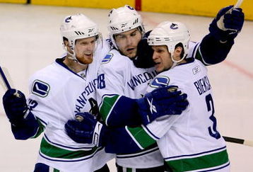 ST LOUIS, MO - APRIL 19: Steve Bernier #18 of the Vancouver Canucks is congratulated by teammates Henrik Sedin #33 and Kevin Bieksa #3 after scoring the go ahead goal against the St Louis Blues in the second period during Game Three of the Western Conference Quarterfinal Round of the 2009 Stanley Cup Playoffs on April 19, 2009 at Scottrade Center in St. Louis, Missouri. (Photo by Matthew Stockman/Getty Images)