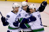 ST LOUIS, MO - APRIL 19: Steve Bernier #18 of the Vancouver Canucks is congratulated by teammates Henrik Sedin #33 and Kevin Bieksa #3 after scoring the go ahead goal against the St Louis Blues in the second period during Game Three of the Western Conference Quarterfinal Round of the 2009 Stanley Cup Playoffs on April 19, 2009 at Scottrade Center in St. Louis, Missouri. (Photo by Matthew Stockman/Getty Images)