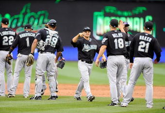 WASHINGTON - APRIL 19:  Cody Ross #12 of the Florida Marlins celebrates with teammates after a 7-4 victory against the Washington Nationals at Nationals Park on April 19, 2009 in Washington, DC.  (Photo by Greg Fiume/Getty Images)