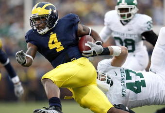 ANN ARBOR, MI - OCTOBER 25:  Brandon Minor #4 of the Michigan Wolverines tries to get around the tackle of Brandon Long #47 of the Michigan State Spartans during a third quarter run on October 25, 2008 at Michigan Stadium in Ann Arbor, Michigan. Michigan State won the game 35-21. (Photo by Gregory Shamus/Getty Images)