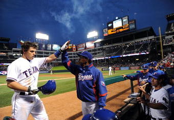 ARLINGTON, TX - APRIL 15:  Ian Kinsler #5 of the Texas Rangers celebrates a solo homerun with manager Ron Washington while wearing jersey #42 to commemorate Jackie Robinson day during a game against the Baltimore Orioles on April 15, 2009 at Rangers Ballpark in Arlington, Texas.  (Photo by Ronald Martinez/Getty Images)