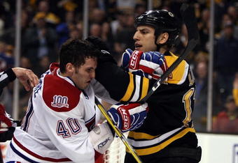 BOSTON - APRIL 18:  Milan Lucic #17 of the Boston Bruins and Maxim Lapierre #40 of the Montreal Canadiens mix it up during Game Two of the Eastern Conference Quarterfinals of the 2009 Stanley Cup playoffs on April 18, 2009 at the TD Banknorth Garden in Boston, Massachusetts. The Bruins defeated the Canadiens 5-1.  (Photo by Elsa/Getty Images)
