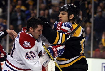 BOSTON - APRIL 18:  Milan Lucic #17 of the Boston Bruins and Maxim Lapierre #40 of the Montreal Canadiens mix it up during Game Two of the Eastern Conference Quarterfinals of the 2009 Stanley Cup playoffs on April 18, 2009 at the TD Banknorth Garden in Boston, Massachusetts. The Bruins defeated the Canadiens 5-1.  (Photo by Elsa/Getty Images)