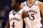 MINNEAPOLIS - MARCH 20:  (L-R) Sherron Collins #4 and Cole Aldrich #45 of the Kansas Jayhawks look on against the North Dakota State Bison during the first round of the NCAA Division I Men's Basketball Tournament at the Hubert H. Humphrey Metrodome on March 20, 2009 in Minneapolis, Minnesota. Kansas won 84-74. (Photo by Jonathan Daniel/Getty Images)