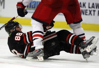 CHICAGO - APRIL 08: Patrick Kane #88 of the Chicago Blackhawks slips and falls under Mike Commodore #22 of the Columbus Blue Jackets on April 8, 2009 at the United Center in Chicago, Illinois. The Blue Jackets defeated the Blackhawks 4-3 in a shootout. (Photo by Jonathan Daniel/Getty Images)