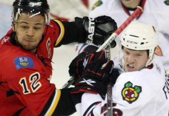 CALGARY, CANADA - APRIL 20: Jarome Iginla #12 of the Calgary Flames and Colin Fraser #46 of the Chicago Blackhawks battle for position during Game Three of the Western Conference Quarterfinals of the 2009 Stanley Cup Playoffs on April 20, 2009 at the Pengrowth Saddledome in Calgary, Alberta, Canada.  (Photo by Mike Ridewood/Getty Images)