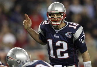 GLENDALE, AZ - FEBRUARY 03:  Tom Brady #12 of of the New England Patriots calls out from under center in the fourth quarter of Super Bowl XLII against the New York Giants on February 3, 2008 at the University of Phoenix Stadium in Glendale, Arizona.  (Photo by Elsa/Getty Images)