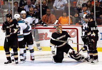 ANAHEIM, CA - APRIL 21:  Referee Mike Hasenfratz signals a goal as Dan Boyle #22 and Milan Michalek #9 of the San Jose Sharks celebrate Boyle's goal in the second period while Sheldon Brookbank #21 and goaltender Jonas Hiller #1 of the Anaheim Ducks look on during Game Three of the Western Conference Quarterfinal Round of the 2009 Stanley Cup Playoffs at Honda Center on April 21, 2009 in Anaheim, California.  (Photo by Harry How/Getty Images)