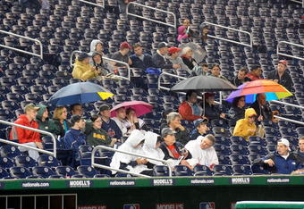 WASHINGTON - APRIL 20:  Fans wait in the stands during a rain delay before the game between the Washington Nationals and the Atlanta Braves at Nationals Park on April 20, 2009 in Washington, DC.  (Photo by Greg Fiume/Getty Images)