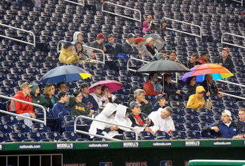 WASHINGTON - APRIL 20:  Fans wait in the stands during a rain delay before the game between the Washington Nationals and the Atlanta Braves at Nationals Park on April 20, 2009 in Washington, DC.  (Photo by Greg Fiume/Getty Images)