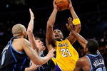 LOS ANGELES, CA - APRIL 21:  Kobe Bryant #24 of the Los Angeles Lakers goes up for a shot between Carlos Boozer #5, Andrei Kirilenko #47 and Paul Millsap #24 of the Utah Jazz in the fourth quarter of Game Two of the Western Conference Quarterfinals during the 2009 NBA Playoffs at Staples Center on April 21, 2009 in Los Angeles, California. NOTE TO USER: User expressly acknowledges and agrees that, by downloading and or using this photograph, User is consenting to the terms and conditions of the Getty Images License Agreement.  (Photo by Kevork Djansezian/Getty Images)