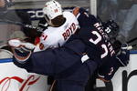 EDMONTON, CANADA - October 18: Dustin Boyd #16 of the Calgary Flames is checked by Steve MacIntyre #33 of the Edmonton Oilers during their NHL game on October 18, 2008 at Rexall Place in Edmonton, Alberta, Canada. (Photo by Dale MacMillan/Getty Images)