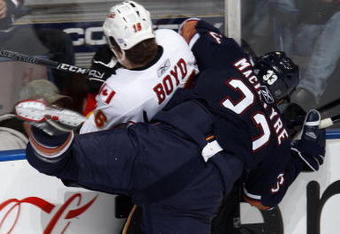 EDMONTON, CANADA - October 18: Dustin Boyd #16 of the Calgary Flames is checked by Steve MacIntyre #33 of the Edmonton Oilers during their NHL game on October 18, 2008 at Rexall Place in Edmonton, Alberta, Canada. (Photo by Dale MacMillan/Getty Images)