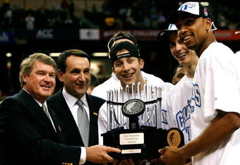 ATLANTA - MARCH 15:  (L-R) ACC Commissioner John Swofford presents the championship trophy to head coach Mike Krzyzewski, Greg Paulus #3, Jon Scheyer #30 and Gerald Henderson #15 of the Duke Blue Devils after their 79-69 win over the Florida State Seminoles in the championship game of the 2009 ACC Men's Basketball Tournament at the Georgia Dome March 15, 2009 in Atlanta, Georgia.  (Photo by Kevin C. Cox/Getty Images)