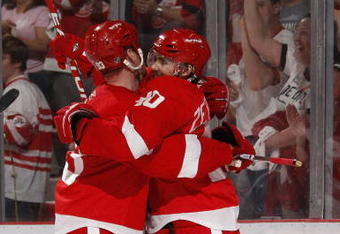 DETROIT - APRIL 18:  Henrik Zetterberg #40 of the Detroit Red Wings celebrates a second period gaol with Johan Franzen #93 while playiny the Columbus Blue Jackets during Game Two of the Western Conference Quarterfinals of the 2009 NHL Stanley Cup Playoffs on April 18, 2009 at Joe Louis Arena in Detroit, Michigan.  (Photo by Gregory Shamus/Getty Images)