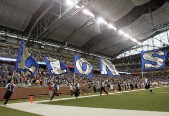 DETROIT - SEPTEMBER 30: Cheer squad carries flags on the field before the game between the Detroit Lions and the Chicago Bears on September 30, 2007 at Ford Field in Detroit, Michigan. The Lions defeated the Bears 37-27. (Photo by Jonathan Daniel/Getty Images)