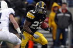 IOWA CITY, IA - NOVEMBER 8:  Runningback Shonn Greene #23 of the Iowa Hawkeyes rushes for yards as free safety Anthony Scirroto #7 of the Penn State Nittany Lions defends in the second quarter of play at Kinnick Stadium on November 8, 2008 in Iowa City, Iowa. Iowa defeated Penn State 24-23. (Photo by David K Purdy/Getty Images)