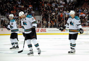 ANAHEIM, CA - APRIL 23:   Patrick Marleau #12, Joe Thornton #19 and Rob Blake #4 of the San Jose Sharks hang their heads as they skate into position for the faceoff during a break in late third period game action en route to a 4-0 loss the Anaheim Ducks during Game Four of the Western Conference Quarterfinal Round of the 2009 Stanley Cup Playoffs at Honda Center on April 23, 2009 in Anaheim, California.  (Photo by Kevork Djansezian/Getty Images)