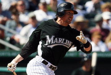 JUPITER, FL - MARCH 3:  John Baker #21 of Florida Marlins makes contact against the Dominican Republic during an exhibition game at Roger Dean Stadium March 3, 2009 in Jupiter, Florida.  (Photo by Doug Benc/Getty Images)