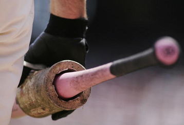 SAN FRANCISCO - MAY 14:  A San Francisco Giants player holds one of the pink Louisville Slugger bats that were distributed as part of MLB's 'Go to Bat Against Breast Cancer' promotion during the game against the Los Angeles Dodgers at AT&T Park May 14, 2006 in San Francisco, California.  (Photo by Jonathan Ferrey/Getty Images)