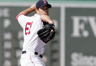 BOSTON - JULY 21:  Kason Gabbard #61 of the Boston Red Sox delivers the pitch against the Chicago White Sox at Fenway Park on July 21, 2007 in Boston, Massachusetts. (Photo by Elsa/Getty Images)