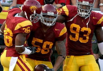 LOS ANGELES, CA - SEPTEMBER 13:  (C) Rey Maualuga #58 of the USC Trojans celebrates with teammates Josh Pinkard #36 and Everson Griffen #93 after Maualuga scored on a 48-yard interception return against the Ohio State Buckeyes during the college football game at the Los Angeles Memorial Coliseum on September 13, 2008 in Los Angeles, California.  (Photo by Stephen Dunn/Getty Images)