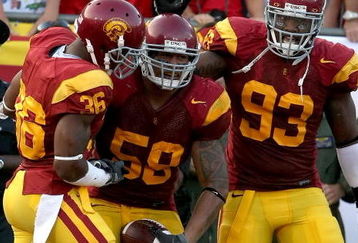LOS ANGELES, CA - SEPTEMBER 13:  (C) Rey Maualuga #58 of the USC Trojans celebrates with teammates Josh Pinkard #36 and Everson Griffen #93 after Maualuga scored on a 48-yard interception return against the Ohio State Buckeyes during the college football game at the Los Angeles Memorial Coliseum on September 13, 2008 in Los Angeles, California.  (Photo by Stephen Dunn/Getty Images)