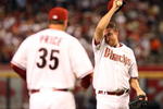 PHOENIX - APRIL 06:  Starting pitcher Brandon Webb #17 of the Arizona Diamondbacks wipes up his face as pitching coach Bryan Price #35 approaches the mound during the MLB openning day game against the Colorado Rockies at Chase Field on April 6, 2009 in Phoenix, Arizona.  The Diamondbacks defeated the Rockies 9-8.  (Photo by Christian Petersen/Getty Images)