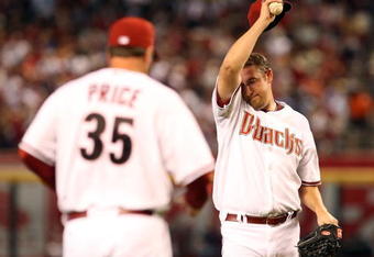 PHOENIX - APRIL 06:  Starting pitcher Brandon Webb #17 of the Arizona Diamondbacks wipes up his face as pitching coach Bryan Price #35 approaches the mound during the MLB openning day game against the Colorado Rockies at Chase Field on April 6, 2009 in Phoenix, Arizona.  The Diamondbacks defeated the Rockies 9-8.  (Photo by Christian Petersen/Getty Images)
